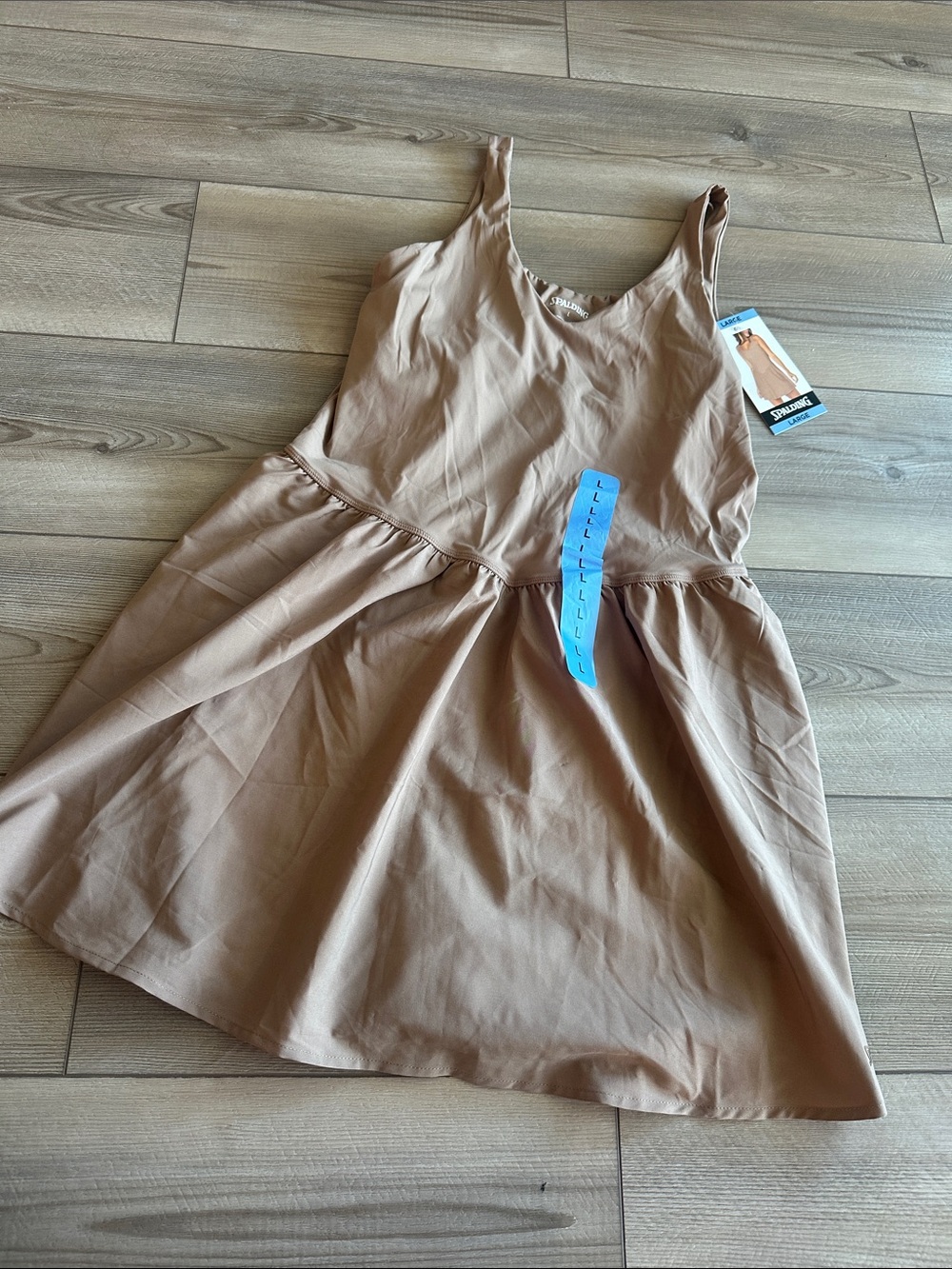 Spalding Soft tan sleeveless dress with a flared skirt.